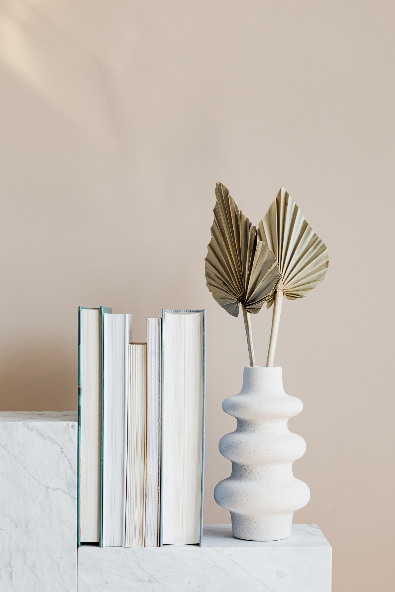 Geometric marble shelf with books and decorative vase